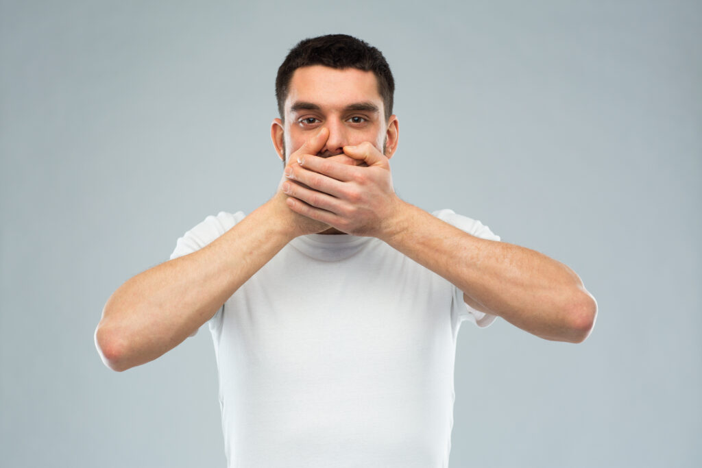 Man covering moutth