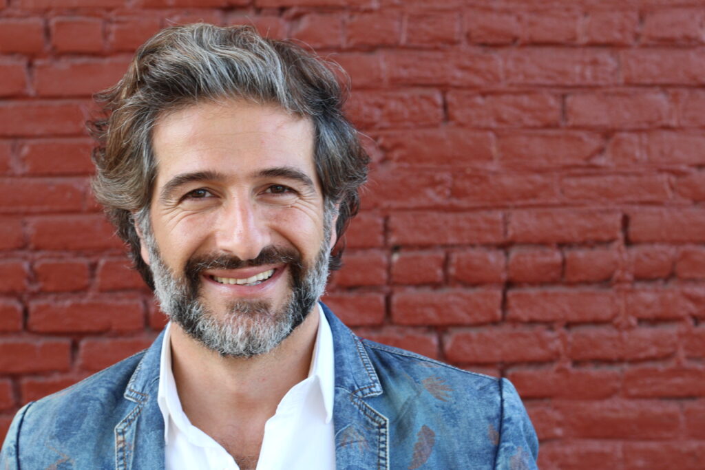 Man smiling on brick background
