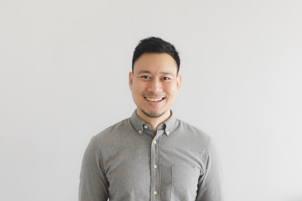 Smiling man on grey background
