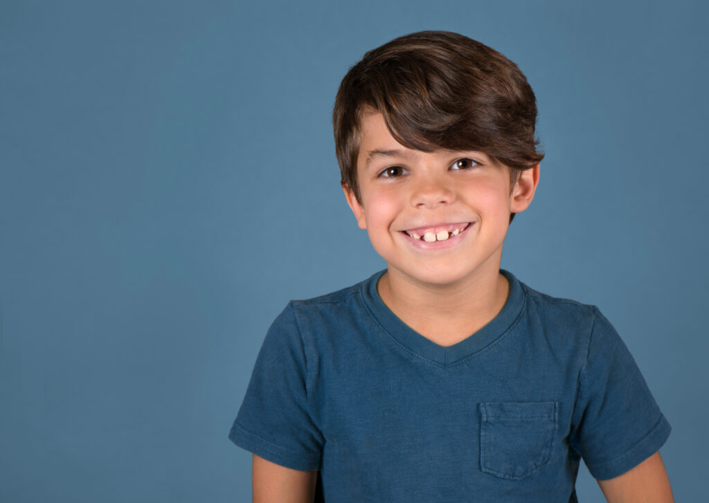 smiling boy blue background