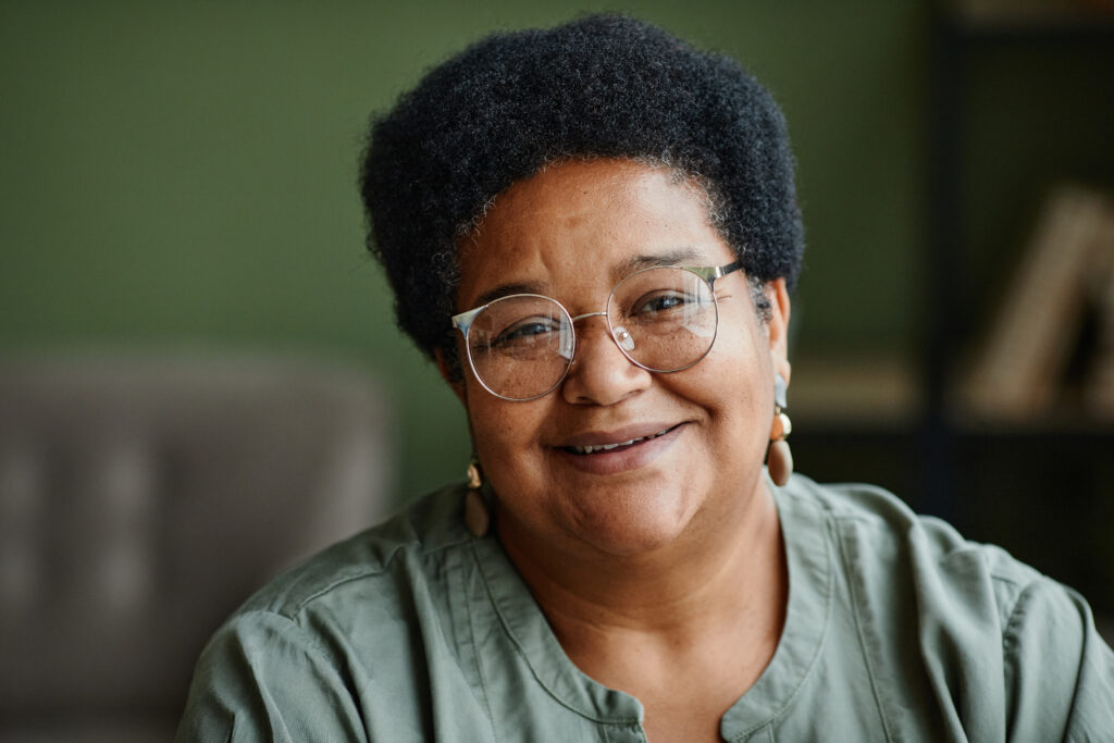 senior woman smiling at camera at home