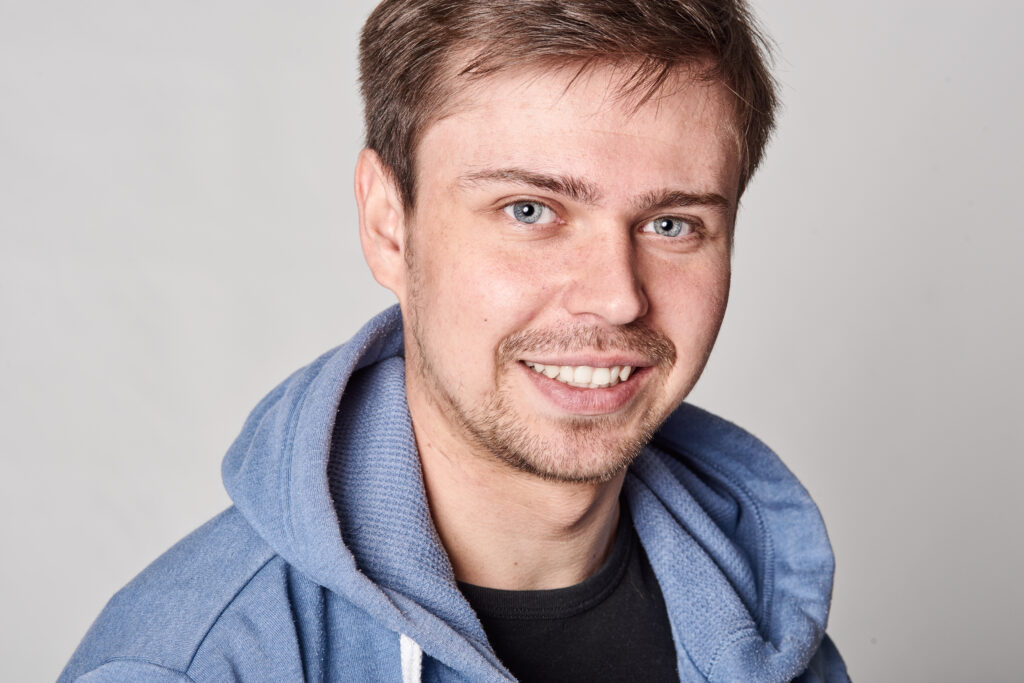 smiling man wearing hoodie