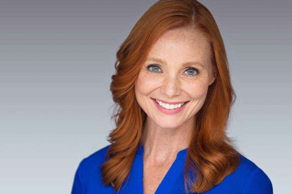 Woman smiling on grey background