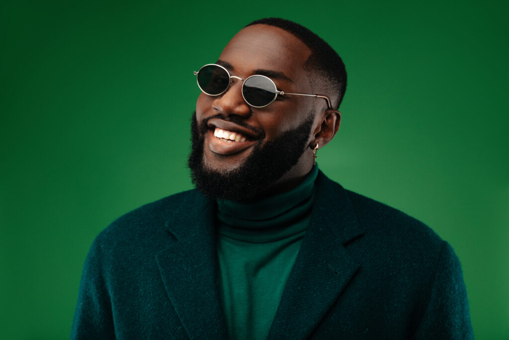 Man in green smiling