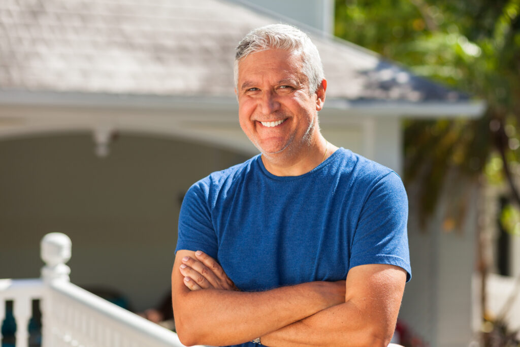 Grey hair man smiling arms crossed