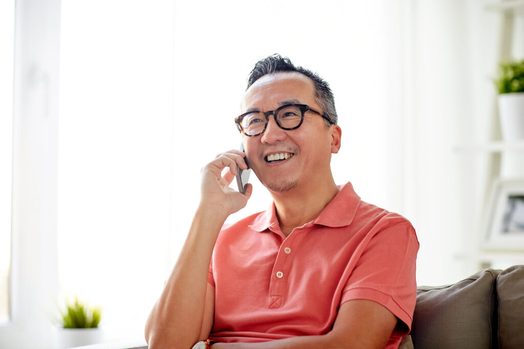 man on cell phone in salmon shirt