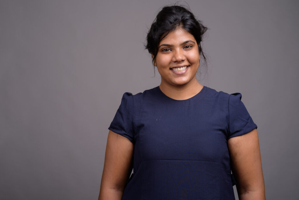 Smiling woman on dark black background