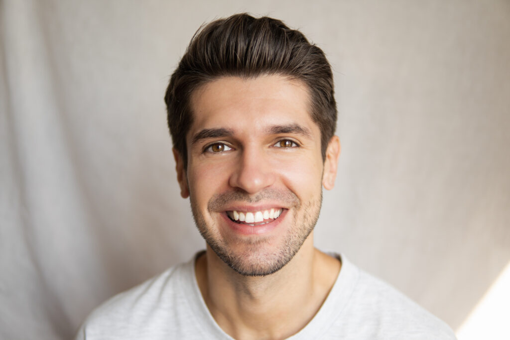 Young man smiling on white background
