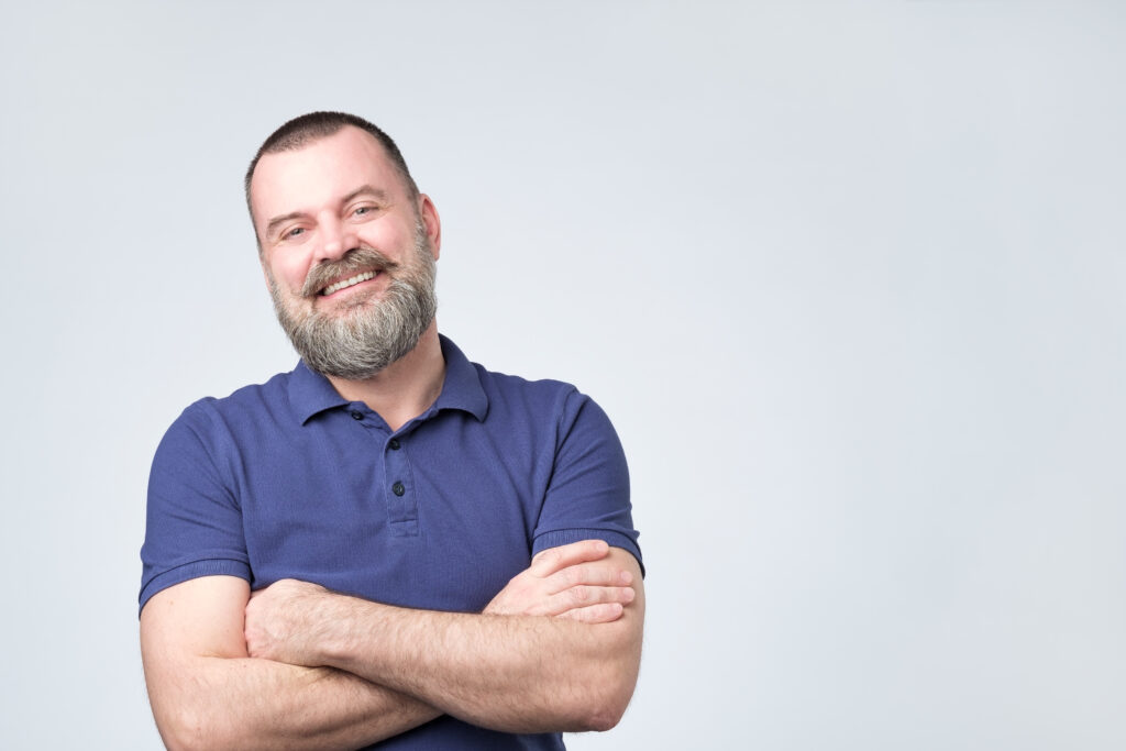 Mature man smiling arms crossed