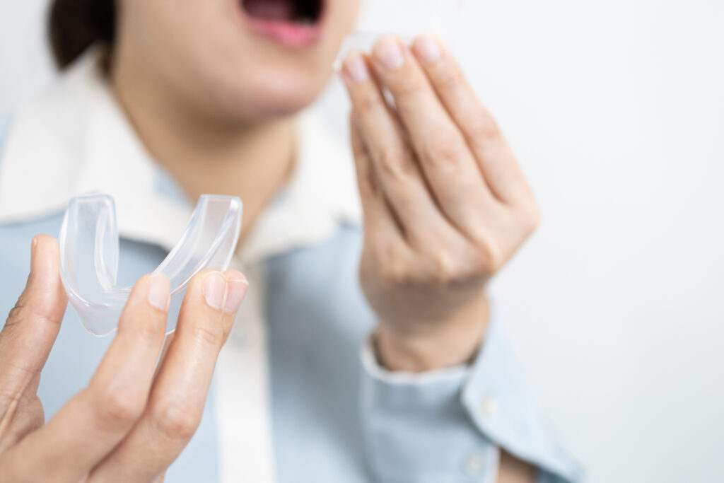 woman holding mouth guard