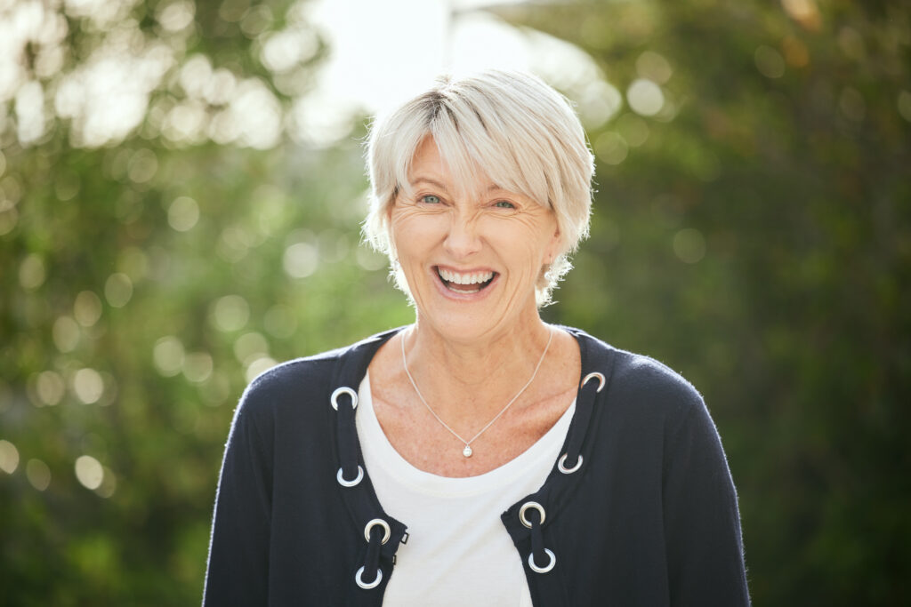 a mature woman standing outside.