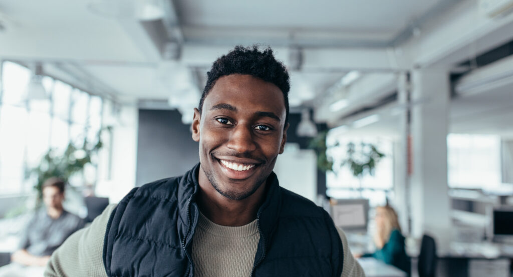 Smiling designer standing in workplace