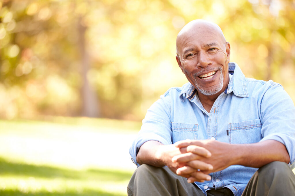 Senior Man Relaxing In Autumn Landscape