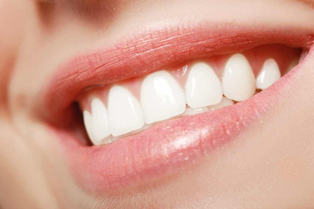 Close up of red beautiful female lips toothy smile